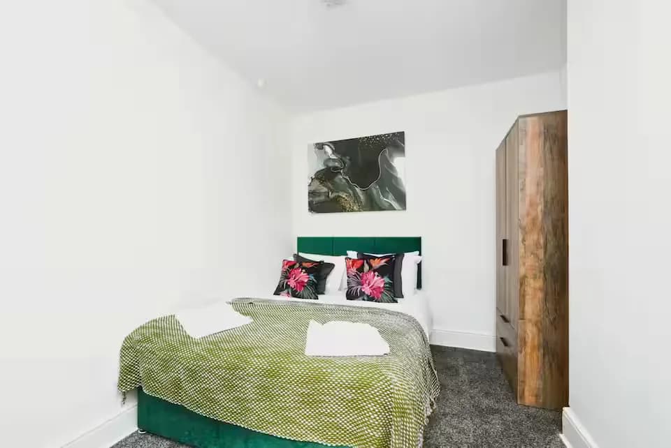 Bedroom with green throw