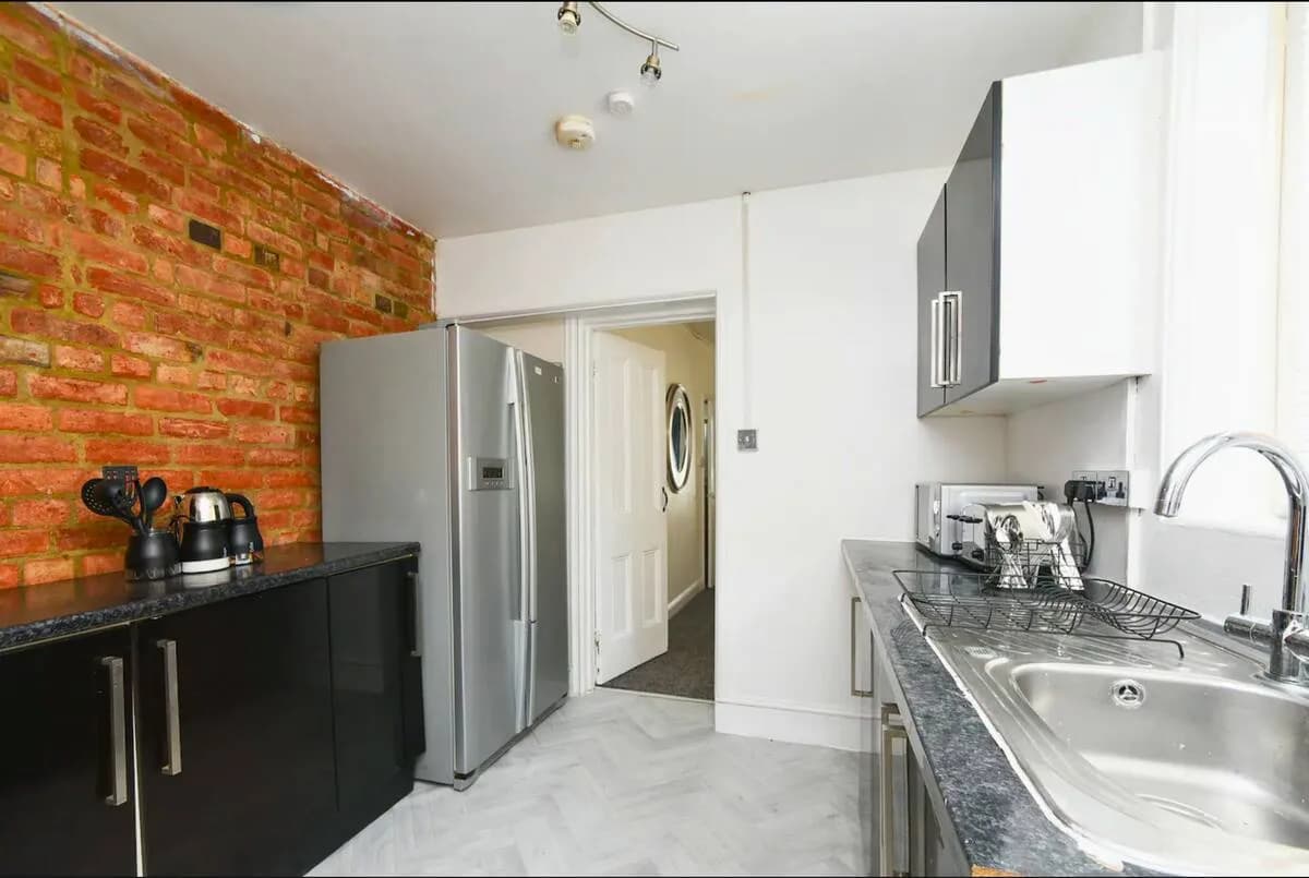 Kitchen with exposed brick wall