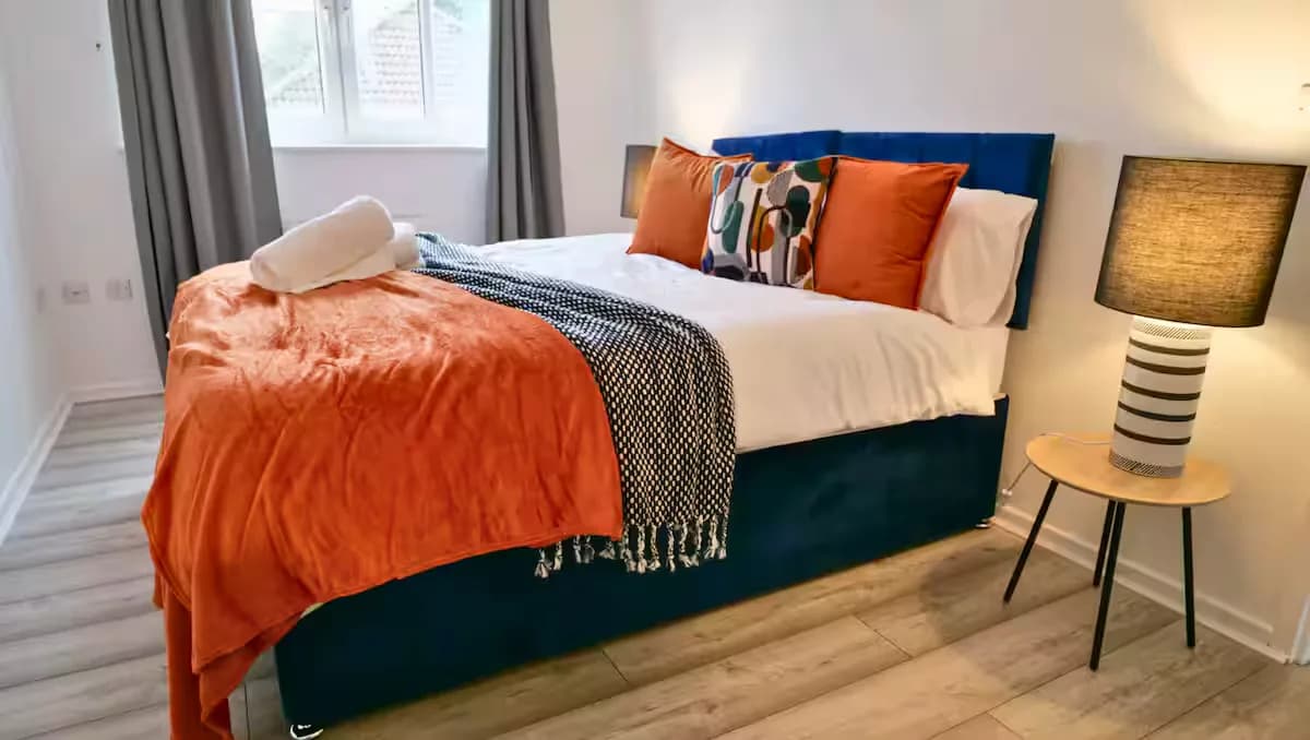 Bedroom with orange throw