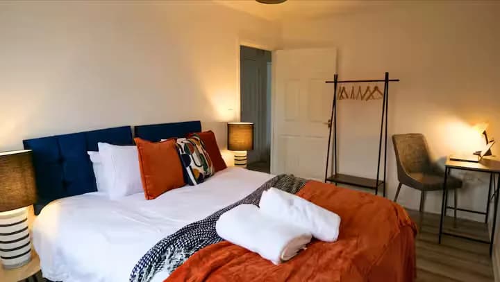 Bedroom with orange throw